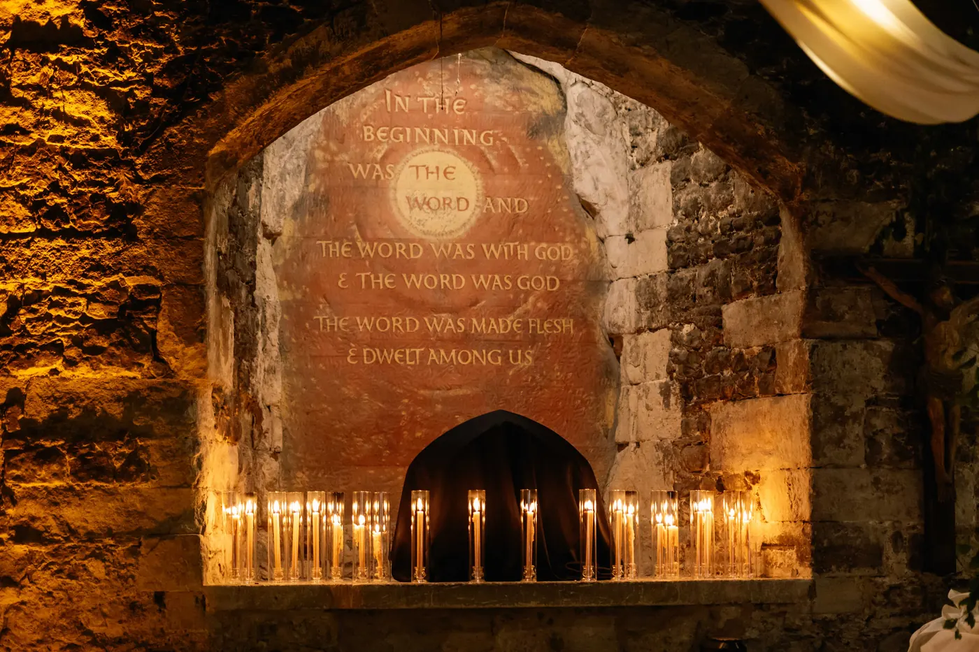Candlelit stone arch inside the 13th-century church
